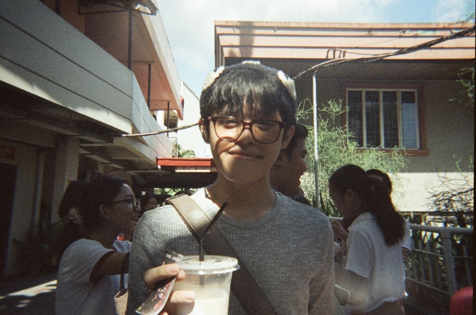 Candid outdoor portrait holding a drink