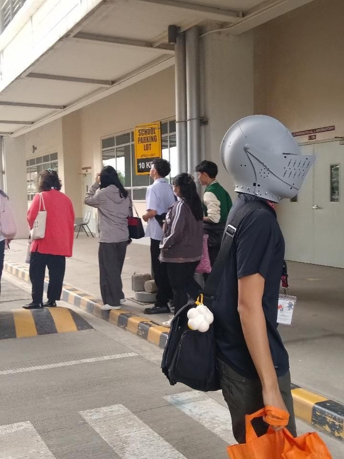 Person walking outside wearing a stylized helmet